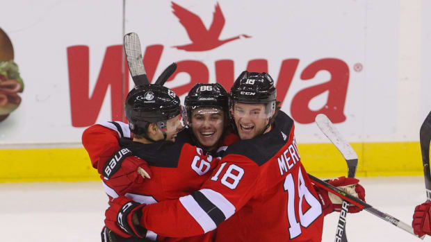 Dec 31, 2021; Newark, New Jersey, USA; New Jersey Devils left wing Jesper Bratt (63), center Jack Hughes (86) and center Dawson Mercer (18) celebrate Hughes  game winning goal against the Edmonton Oilers during overtime at Prudential Center. Mandatory Credit: Ed Mulholland-USA TODAY Sports